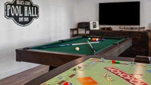 a pool table in a room with a pool ball on it at Hidden Oaks Farmhouse by AvantStay Hot Tub Deck in Atascadero