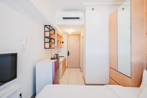 a small apartment with a hallway leading to a kitchen at Tokyo Riverside Apartment @ PIK 2 in Tangerang