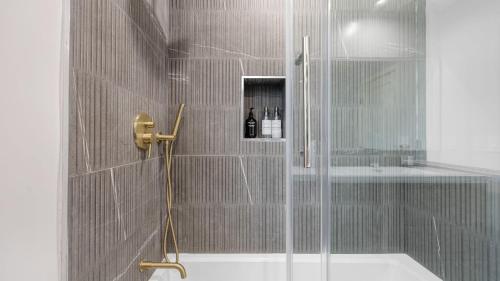 a shower with a glass door in a bathroom at Fulton I by AvantStay Modern Haven in Downtown in Los Angeles