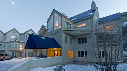 a building with a blue awning in the snow at Viking Lodge 103 by AvantStay Stunning Condo Near Ski Lift in Telluride