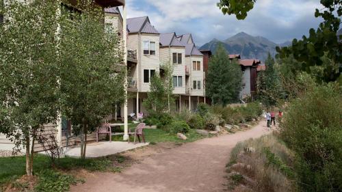 a group of houses on a dirt road in a town at Viking Lodge 103 by AvantStay Stunning Condo Near Ski Lift in Telluride