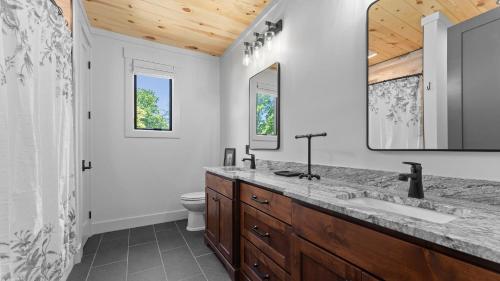 Ένα μπάνιο στο Blue Heron Gray Fox by AvantStay 2 Lakefront Homes Sleeps 44 Pool Dock Theater
