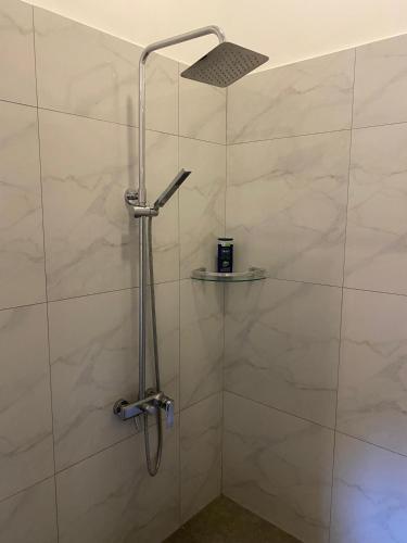 a bathroom with a shower with a glass door at Stadler Resort in Wadduwa