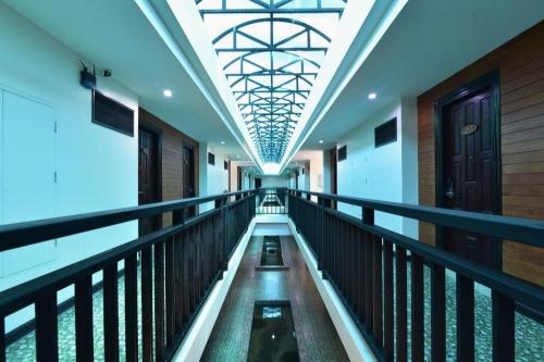 an empty corridor of a building with a ceiling at The Green Hotel in Ko Lipe
