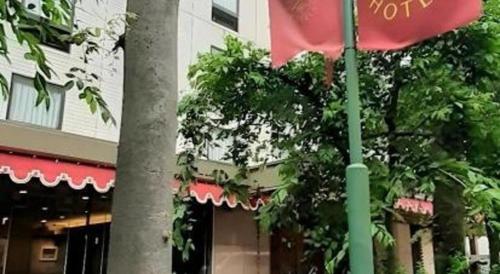 a pole with a flag in front of a building at Diamond Hotel Tokyo in Tokyo