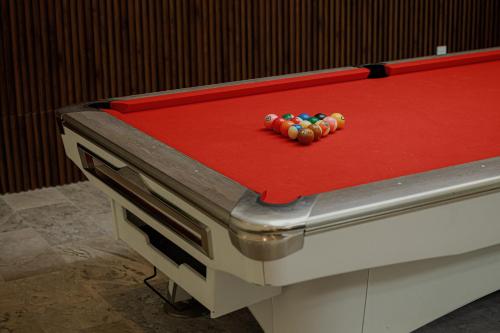 a toy on top of a red pool table at Valley De Mango Hue in Thôn Châu Chữ