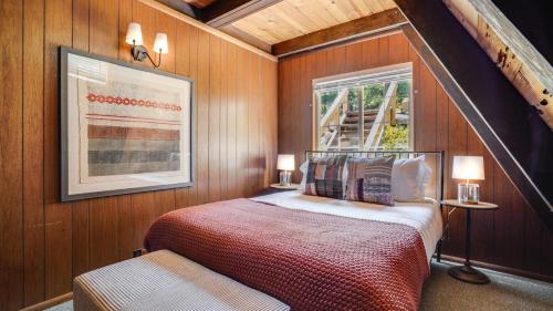 a bedroom with a large bed and a window at Horizon by AvantStay Stunning A-frame Cabin w Hot Tub Billiards Lake Views in Tahoe City