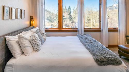 a bed in a room with a large window at Adams Ranch Retreat by AvantStay Free Shuttle 2 Mountain Village Telluride Ski Resort in Telluride