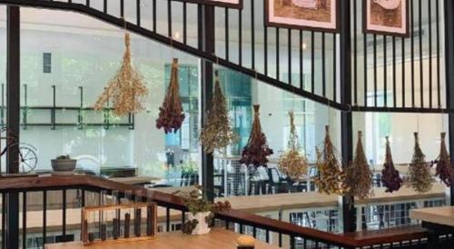 a restaurant with christmas trees hanging from the ceiling at Valaya Hotel Pathumthani in Pathum Thani