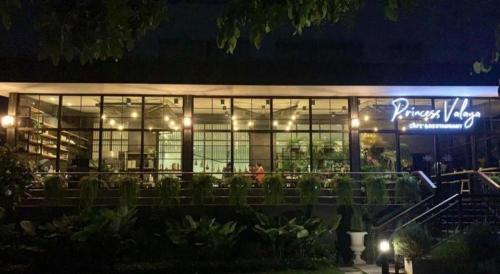 a large building with lights in front of it at night at Valaya Hotel Pathumthani in Pathum Thani