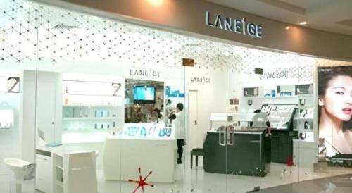 a cosmetics store with a woman on the wall at Kiulap Plaza Hotel in Bandar Seri Begawan