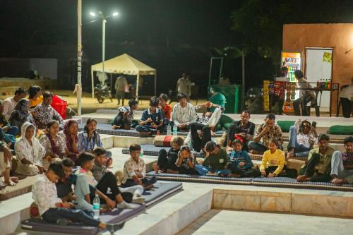 a group of people sitting on the steps of a stage at Marina Luxery resort Jaisalmer in Jaisalmer