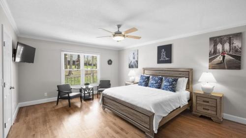 a bedroom with a bed and a ceiling fan at Porch Paradise by AvantStay New Pool Firepit in Mooresville