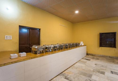 a waiting room with a row of silver dishes at Marina Luxery resort Jaisalmer in Jaisalmer