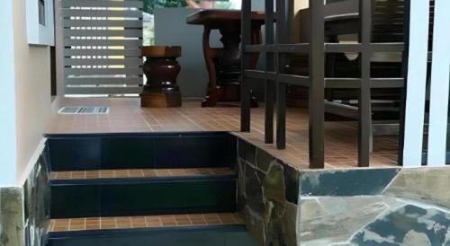 a set of stairs in a house with a hot tub at Tong Hotel in Maha Sarakham