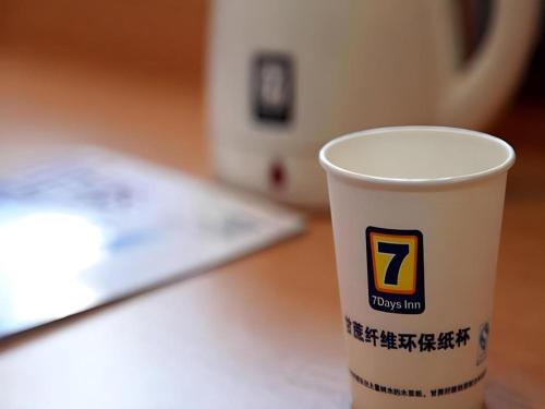 a cup of coffee sitting on a table at 7 Days Inn Beijing Shunyi Development Area Mordern Motor City in Beijing