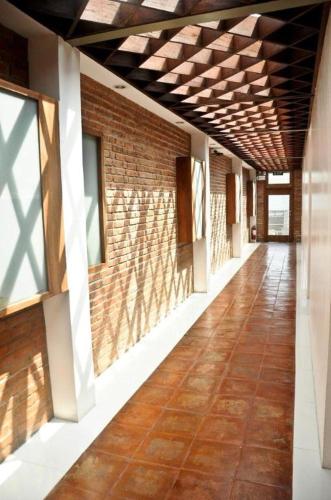 an empty hallway of a building with a brick wall at Mango Valley Hotel in Olongapo