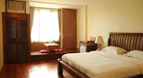 a bedroom with a large bed and a window at Mango Valley Hotel in Olongapo