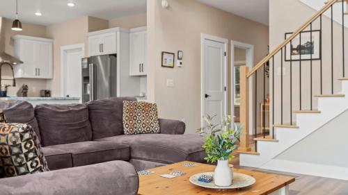 a living room with a couch and a table at Lakeside Serenity by AvantStay Lakefront Newly Built Deck w Views in White Haven