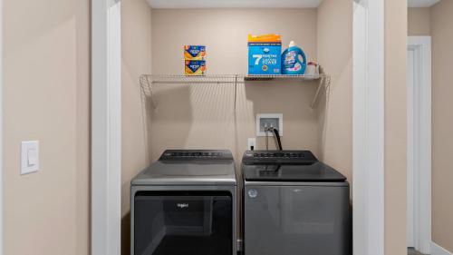 a small kitchen with a stove and a shelf at Lakeside Serenity by AvantStay Lakefront Newly Built Deck w Views in White Haven