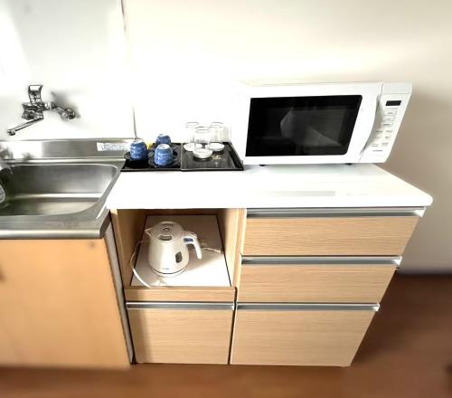 a microwave oven sitting on top of a kitchen counter at 飯野小屋 in Marugame