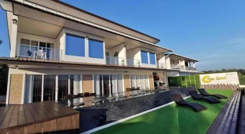a house with a green lawn in front of it at C View Home in Nan