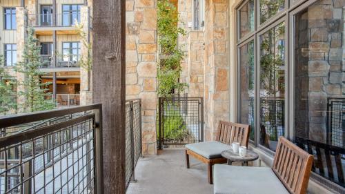 a balcony with two chairs and a table at Kestrel by AvantStay Close to the Ski Slopes in this Majestic Home in Park City in Park City