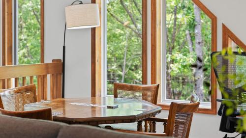 a dining room with a table and chairs and a window at Maple Oasis by AvantStay Newly Built w Hot Tub Game Room Fire Pit in Blakeslee