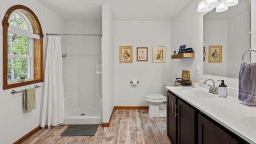 a white bathroom with a sink and a shower at Maple Oasis by AvantStay Newly Built w Hot Tub Game Room Fire Pit in Blakeslee