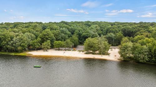 an aerial view of an island in the middle of a lake at Maple Oasis by AvantStay Newly Built w Hot Tub Game Room Fire Pit in Blakeslee