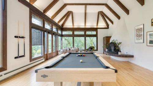 a pool table in a room with windows at Malvasia by AvantStay Luxe Wine Country Retreat in Santa Rosa