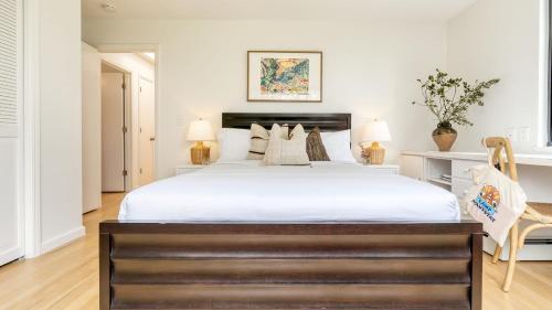 a bedroom with a large bed with white sheets at Malvasia by AvantStay Luxe Wine Country Retreat in Santa Rosa