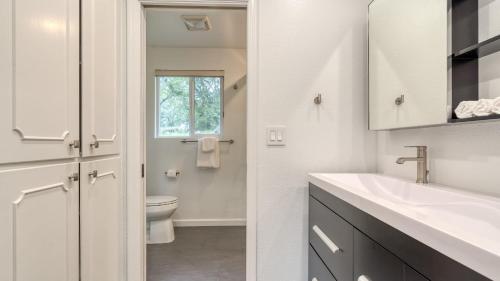 a white bathroom with a sink and a toilet at Malvasia by AvantStay Luxe Wine Country Retreat in Santa Rosa