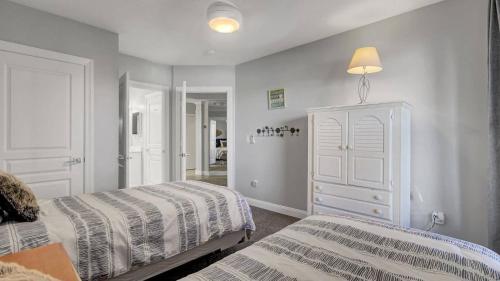 a bedroom with two beds and a dresser at Beachfront 3BDR Condo with Pool & Deck Ocean Views Ocean Blvd #102 by AvantStay in Isle of Palms