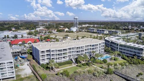 an aerial view of a large building with a resort at Beachfront 3BDR Condo with Pool & Deck Ocean Views Ocean Blvd #102 by AvantStay in Isle of Palms