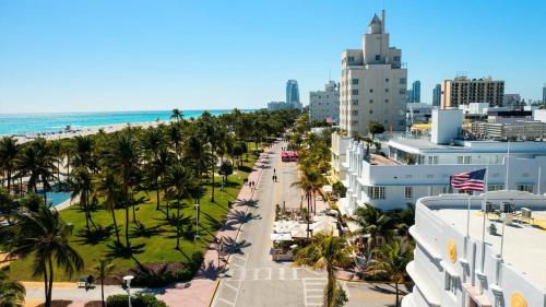 an aerial view of a beach with palm trees and buildings at Beachfront 3BDR Condo with Pool & Deck Ocean Views Ocean Blvd #102 by AvantStay in Isle of Palms