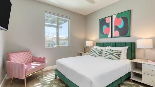 a bedroom with a bed and a chair at Desert Eden by AvantStay 6BR w Ensuite Backyard Oasis w Pool Hot Tub in Coachella