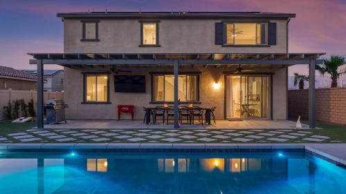 a house with a swimming pool in front of a house at Desert Eden by AvantStay 6BR w Ensuite Backyard Oasis w Pool Hot Tub in Coachella