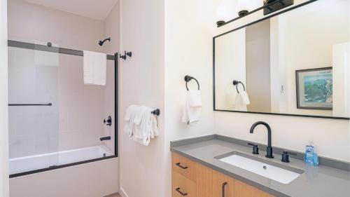 a bathroom with a sink and a shower at Manitou Riverhouse 115 by AvantStay Spacious Condo in the Centre of Telluride in Telluride
