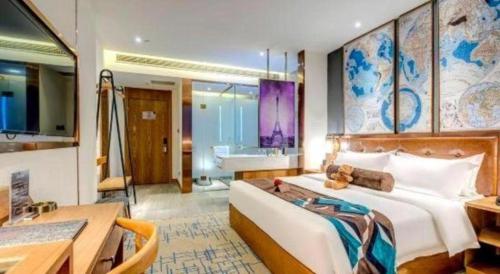 a bedroom with a bed and a desk and a bathroom at James Joyce Coffetel·Anyang Text Museum in Anyang