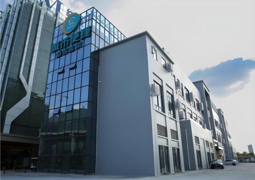 a large glass building with a large door on it at City Comfort Inn Wuhan Ikea in Wuhan