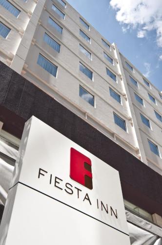 a fed ex sign in front of a building at Fiesta Inn Playa del Carmen in Playa del Carmen