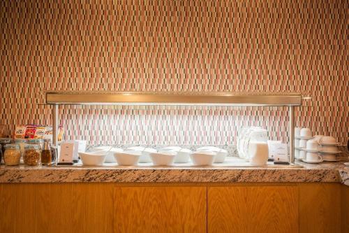 a counter with a bunch of white bowls on it at Fiesta Inn Playa del Carmen in Playa del Carmen