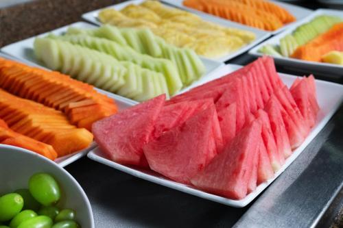 a bunch of different types of fruits and vegetables on plates at Fiesta Inn Playa del Carmen in Playa del Carmen