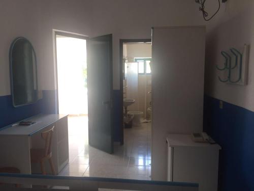 a bathroom with a sink and a toilet and a mirror at Villa Petrusa in Stromboli