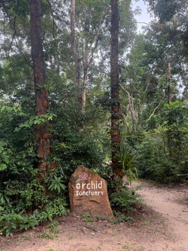 a sign in the middle of a forest at Dugong Bay - Làng Ẩm Thực & Sinh Thái - Eco & Seafood Village in Phu Quoc