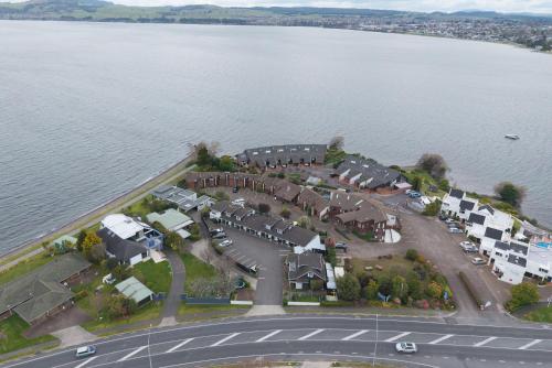 an aerial view of a house by the water at Cottage Mews Motel in Taupo