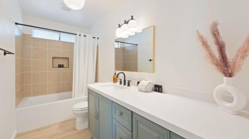 a bathroom with a sink and a toilet and a shower at Carmella by AvantStay Modern JTree Home w Large Outdoor Area in Twentynine Palms