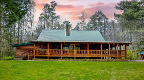 a large log cabin with a green roof at Twin Creeks Lodge by AvantStay 33 Acre Retreat in Brevard