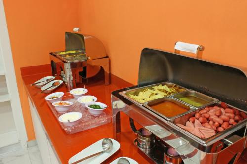 a breakfast buffet with food on a table at One Monterrey Tecnologico in Monterrey